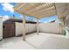 Outdoor patio area featuring a lattice overhang and a concrete floor, ideal for entertaining and relaxation at 8377 E Indian School Rd, Scottsdale, AZ 85251