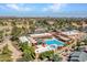 Aerial view shows community pool with lounge seating, umbrellas, spa and other outdoor amenities at 8541 W Rosemonte Dr, Peoria, AZ 85382