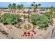 Aerial view showcasing a community clock tower and residential area with palm trees and solar panels at 8541 W Rosemonte Dr, Peoria, AZ 85382