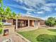 Backyard with a covered patio and lush green grass at 8541 W Rosemonte Dr, Peoria, AZ 85382