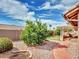 Lush backyard with an orange tree, red brick pathway, and privacy wall, creating a serene outdoor oasis at 8541 W Rosemonte Dr, Peoria, AZ 85382