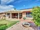 Landscaped backyard featuring a covered patio, orange tree, and solar panels providing a tranquil outdoor space at 8541 W Rosemonte Dr, Peoria, AZ 85382