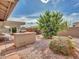 Landscaped backyard with an outdoor kitchen and covered patio at 8541 W Rosemonte Dr, Peoria, AZ 85382