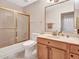 Bathroom with a wood vanity, shower-tub combo, and tile flooring at 8541 W Rosemonte Dr, Peoria, AZ 85382