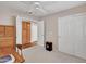 Carpeted bedroom featuring a ceiling fan and closet with sliding doors at 8541 W Rosemonte Dr, Peoria, AZ 85382