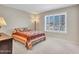 Bedroom featuring a window with shutters and a comfortable bed at 8541 W Rosemonte Dr, Peoria, AZ 85382