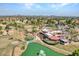 Aerial view featuring the clubhouse, pond with fountain, and golf course fairway at 8541 W Rosemonte Dr, Peoria, AZ 85382