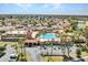 An aerial shot of the community pool area, tennis courts, palm trees, and common area at 8541 W Rosemonte Dr, Peoria, AZ 85382