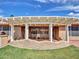 Inviting covered patio featuring a white pergola, tiled flooring, and a textured half-wall providing shade and style at 8541 W Rosemonte Dr, Peoria, AZ 85382