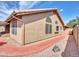 Exterior view of the house showing textured stucco, a red walkway, and well-maintained landscaping at 8541 W Rosemonte Dr, Peoria, AZ 85382