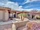 Attractive home features desert landscaping with mature shrubbery surrounding the walkway to the front entrance at 8541 W Rosemonte Dr, Peoria, AZ 85382