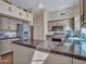 Well-lit kitchen featuring modern appliances, granite counters, and abundant cabinet space for efficient meal preparation at 8541 W Rosemonte Dr, Peoria, AZ 85382