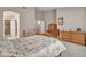 Serene main bedroom featuring a four-poster bed, neutral color palette, and a glimpse into the en-suite bathroom at 8541 W Rosemonte Dr, Peoria, AZ 85382