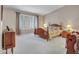 Cozy main bedroom featuring a four-poster bed, plantation shutters, and plush carpeting at 8541 W Rosemonte Dr, Peoria, AZ 85382