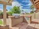 Outdoor grill with brick pavers and backyard views at 8541 W Rosemonte Dr, Peoria, AZ 85382