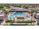 Aerial view of a community pool area with lounge seating, umbrellas, spa and other outdoor amenities at 8541 W Rosemonte Dr, Peoria, AZ 85382