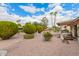 Low maintenance backyard with gravel landscaping, lush greenery, and a covered patio at 980 Leisure World --, Mesa, AZ 85206