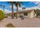 Rear exterior features desert landscaping, palm trees, and a low-maintenance yard at 980 Leisure World --, Mesa, AZ 85206