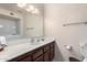 Bright bathroom featuring a long vanity with dark wood cabinets and a big mirror at 980 Leisure World --, Mesa, AZ 85206