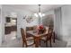 Inviting dining area with a wooden table, floral centerpiece, and decorative wall art at 980 Leisure World --, Mesa, AZ 85206