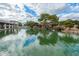 Peaceful view of a tranquil pond reflecting the surrounding buildings and trees under a partly cloudy sky at 980 Leisure World --, Mesa, AZ 85206