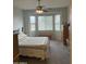 Comfortable bedroom featuring neutral decor, a ceiling fan, and plenty of natural light from the window at 10 N Agua Fria Ln, Casa Grande, AZ 85194