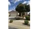 Charming single story home featuring a two car garage, desert landscaping, and beautiful mature shade tree at 10 N Agua Fria Ln, Casa Grande, AZ 85194