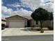 Charming single story home featuring a two car garage, desert landscaping, and beautiful mature shade tree at 10 N Agua Fria Ln, Casa Grande, AZ 85194