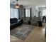 Cozy living room featuring a ceiling fan, neutral walls, tile floors, and comfortable seating at 10 N Agua Fria Ln, Casa Grande, AZ 85194