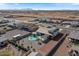 Elevated view of a suburban property with a pool, landscaping, and desert backdrop at 10256 W Appaloosa Trl, Casa Grande, AZ 85194