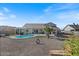 Wide shot of a backyard showcasing the pool and covered patio, perfect for outdoor entertaining and relaxation at 10256 W Appaloosa Trl, Casa Grande, AZ 85194