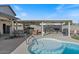 Inviting backyard with a pool, outdoor kitchen, and covered seating area at 10256 W Appaloosa Trl, Casa Grande, AZ 85194