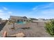 Expansive backyard featuring a pool, covered patio, and ample gravel landscaping at 10256 W Appaloosa Trl, Casa Grande, AZ 85194