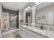 Bright bathroom featuring granite counters, dual sinks, and a glass shower at 10256 W Appaloosa Trl, Casa Grande, AZ 85194