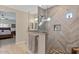 Modern bathroom featuring herringbone tile in the shower, a glass shower door, and wood-look tile floors at 10256 W Appaloosa Trl, Casa Grande, AZ 85194