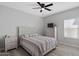 Cozy bedroom with neutral colors, ceiling fan, and wood-look tile floors at 10256 W Appaloosa Trl, Casa Grande, AZ 85194