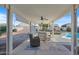 Inviting covered patio with ceiling fans, outdoor seating, and views of the pool and landscaped backyard at 10256 W Appaloosa Trl, Casa Grande, AZ 85194