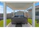 Relaxing hot tub under a covered patio area with artificial turf surround at 10256 W Appaloosa Trl, Casa Grande, AZ 85194