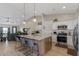 Open kitchen featuring white cabinets, granite counters, stainless appliances, and an island with seating at 10256 W Appaloosa Trl, Casa Grande, AZ 85194