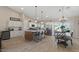 Modern kitchen featuring white cabinetry, stainless steel appliances, and a large island with seating for four at 10256 W Appaloosa Trl, Casa Grande, AZ 85194