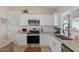 Kitchen featuring white cabinets, stainless steel appliances, granite countertops, and subway tile backsplash at 10256 W Appaloosa Trl, Casa Grande, AZ 85194