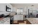 Kitchen showcasing stainless steel appliances, granite countertops, white cabinetry and subway tile backsplash at 10256 W Appaloosa Trl, Casa Grande, AZ 85194