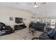 Comfortable living area with a ceiling fan, TV, massage chair, and modern decor creating a relaxing space at 10256 W Appaloosa Trl, Casa Grande, AZ 85194