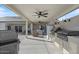 Spacious covered outdoor kitchen with a grill, refrigerator, and bar area, perfect for entertaining guests at 10256 W Appaloosa Trl, Casa Grande, AZ 85194