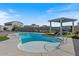 Beautiful backyard pool with a baja shelf, water feature, and covered patio, perfect for outdoor entertaining at 10256 W Appaloosa Trl, Casa Grande, AZ 85194