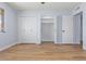 Neutral bedroom features closet systems, wood-look flooring, and is freshly painted at 10839 W Peoria Ave, Sun City, AZ 85351