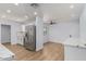 Beautiful kitchen with white cabinetry, stainless steel appliances, quartz countertops, and wood floors at 10839 W Peoria Ave, Sun City, AZ 85351