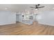 Spacious living room and kitchen featuring modern appliances, wood floors, recessed lighting, and neutral colors at 10839 W Peoria Ave, Sun City, AZ 85351