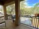 Balcony view with black metal railing and treetop views, adding to the home's charm at 1131 W Sierra Madre Ave, Gilbert, AZ 85233