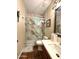 Modern bathroom featuring a marble-tiled shower with a glass door and brushed nickel fixtures at 1131 W Sierra Madre Ave, Gilbert, AZ 85233